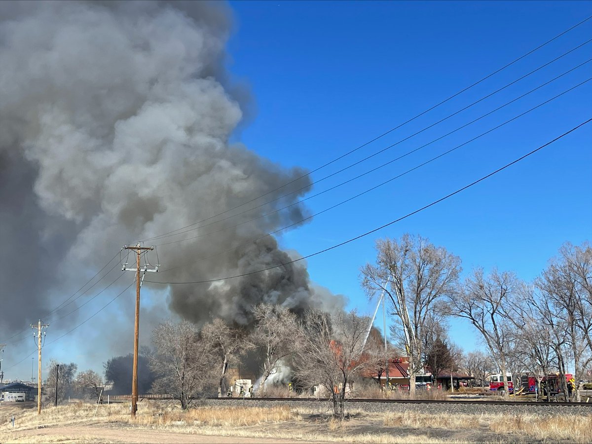 Crews are battling a building fire on West 29th Street, east of I-25, and are asking people to avoid the area